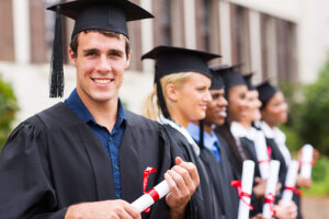 Row of Ph.D. in sports psychology graduates in cap and gown with diplomas